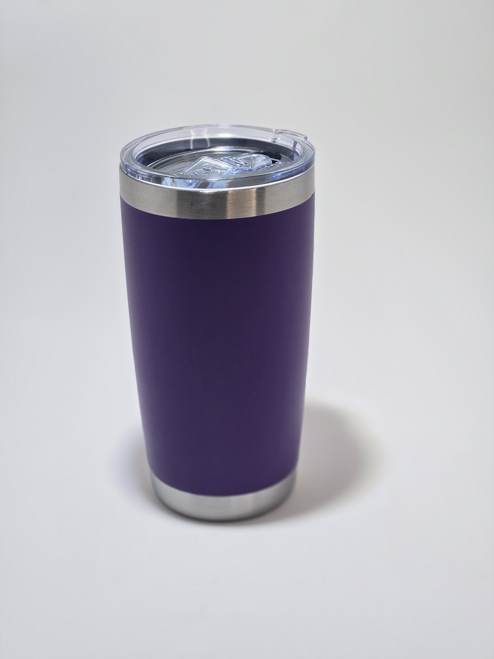 Purple insulated travel tumbler with a clear lid.