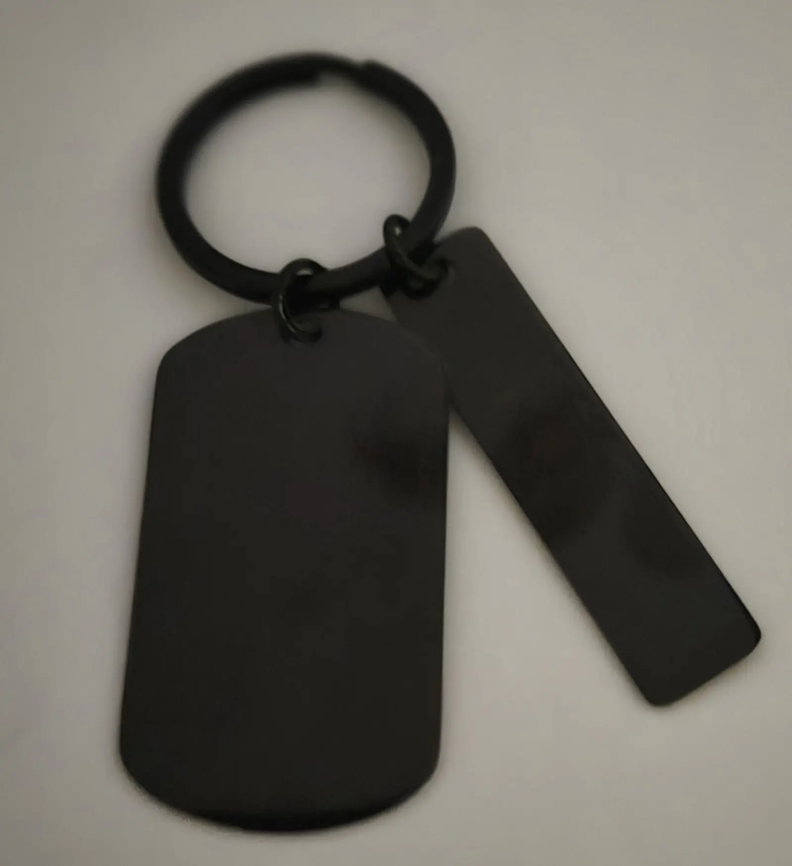 Black metal keychain with two attached tags on a ring.