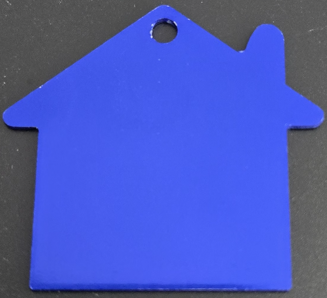 Blue house-shaped keychain with a small hole for attachment.