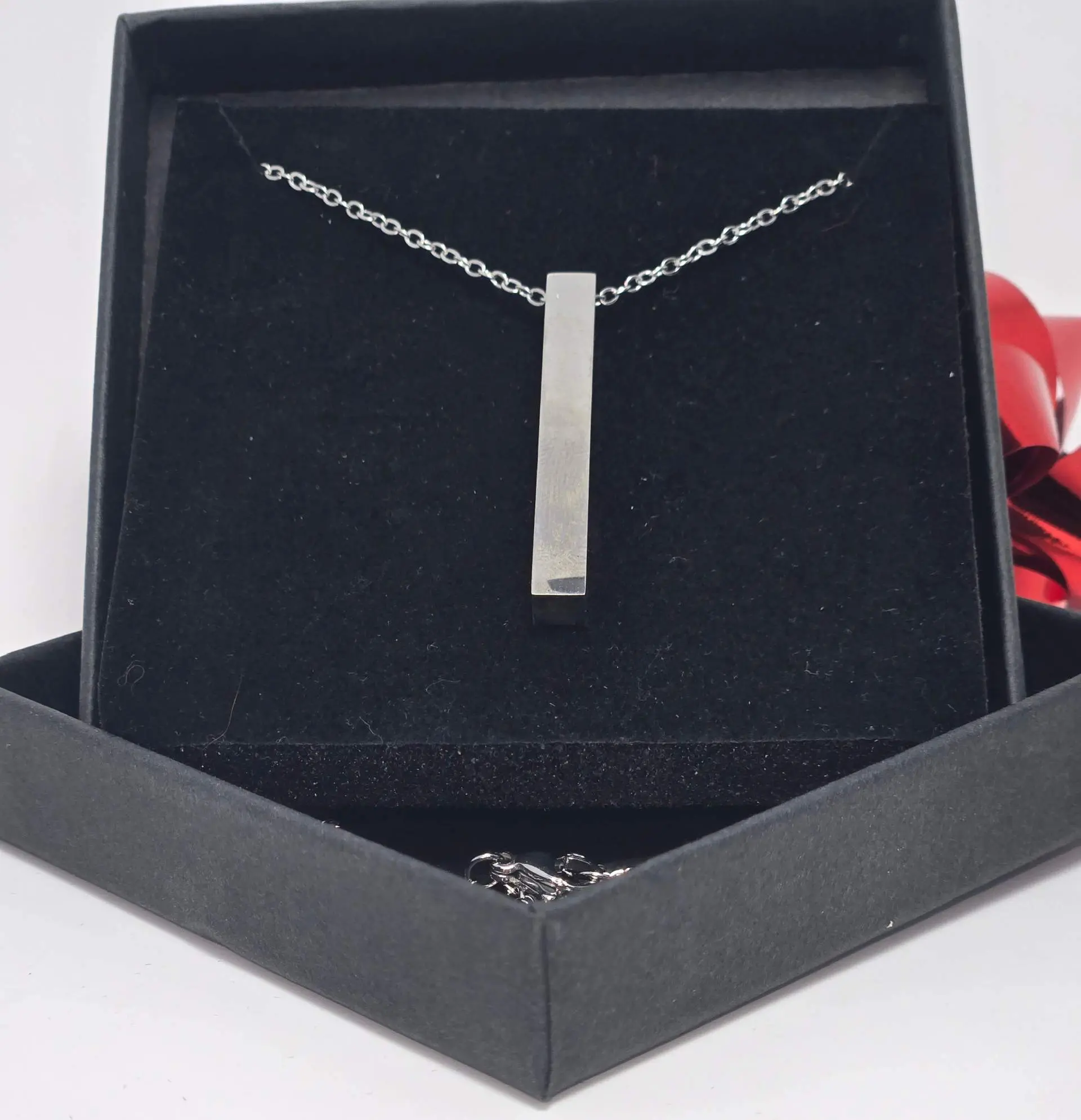 Elegant silver pendant necklace in a black gift box.