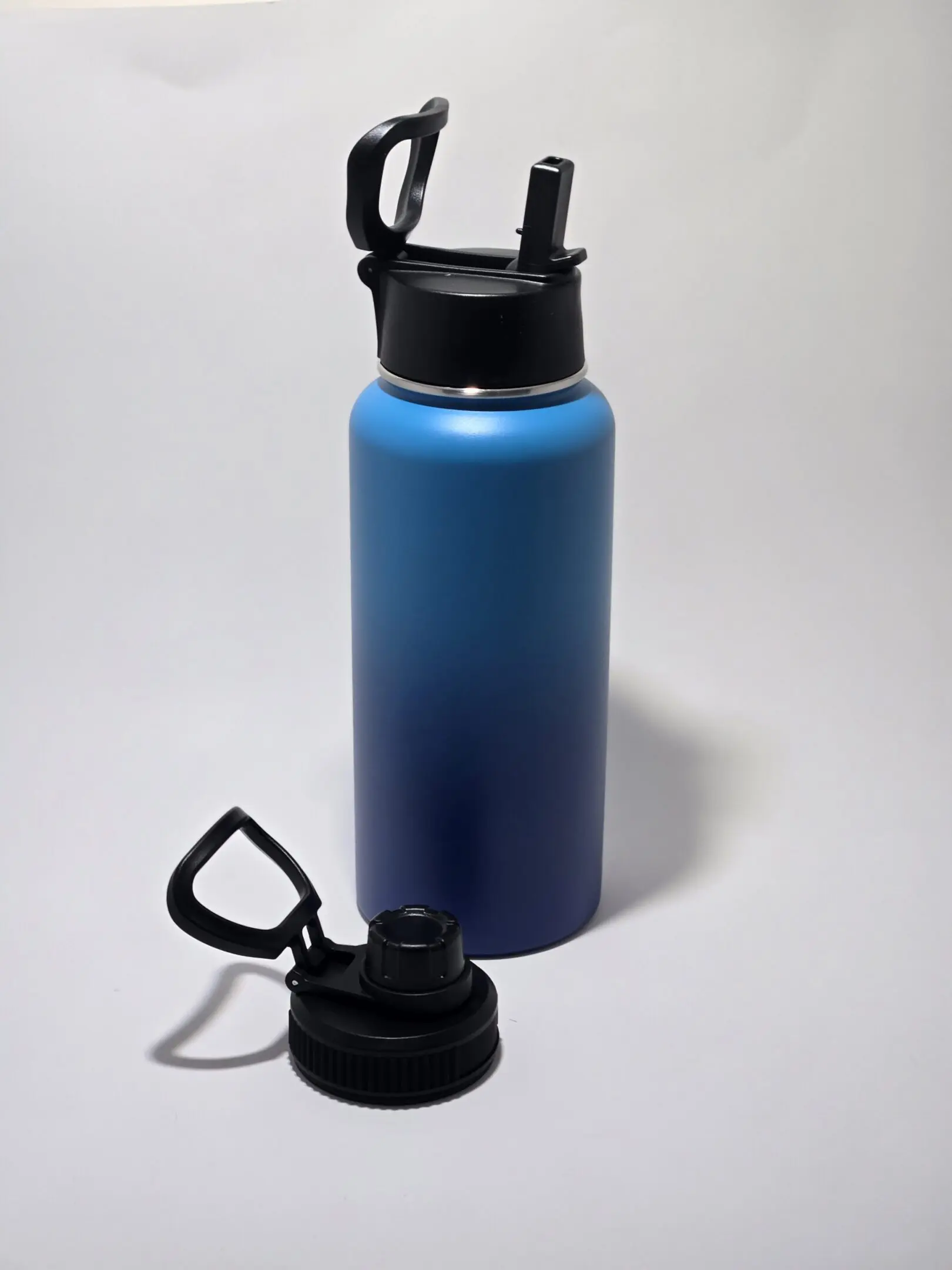 Blue gradient water bottle with a black cap and carabiner.