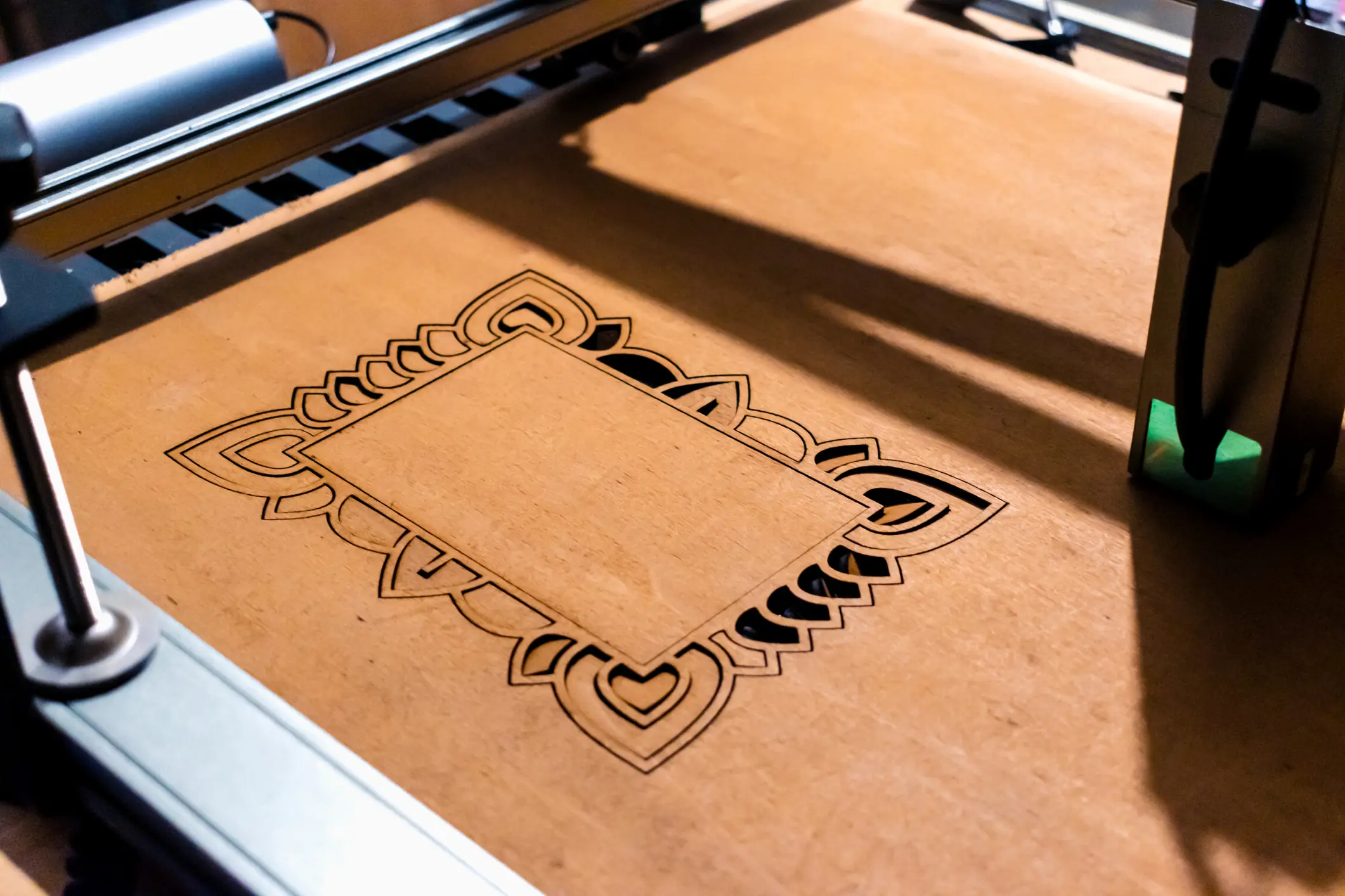 Close-up of a laser-cut wooden design with intricate patterns.