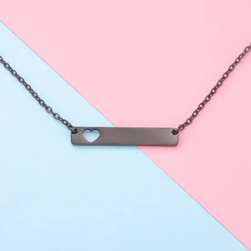 Minimalist bar necklace with a small heart cutout on a pastel pink and blue background.
