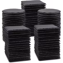 Stacks of black square tiles arranged in groups.