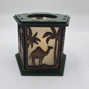Decorative lantern with animal and tree silhouettes.